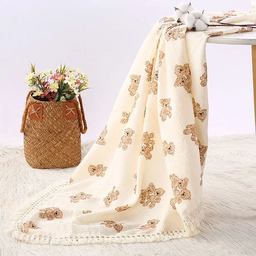 "Featuring a charming bear design and breathable cotton muslin fabric, this blanket is made for sweet dreams and gentle cuddles."
