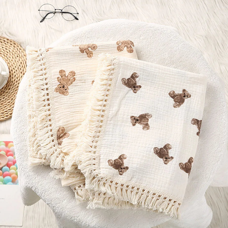 "Featuring a charming bear design and breathable cotton muslin fabric, this blanket is made for sweet dreams and gentle cuddles."
