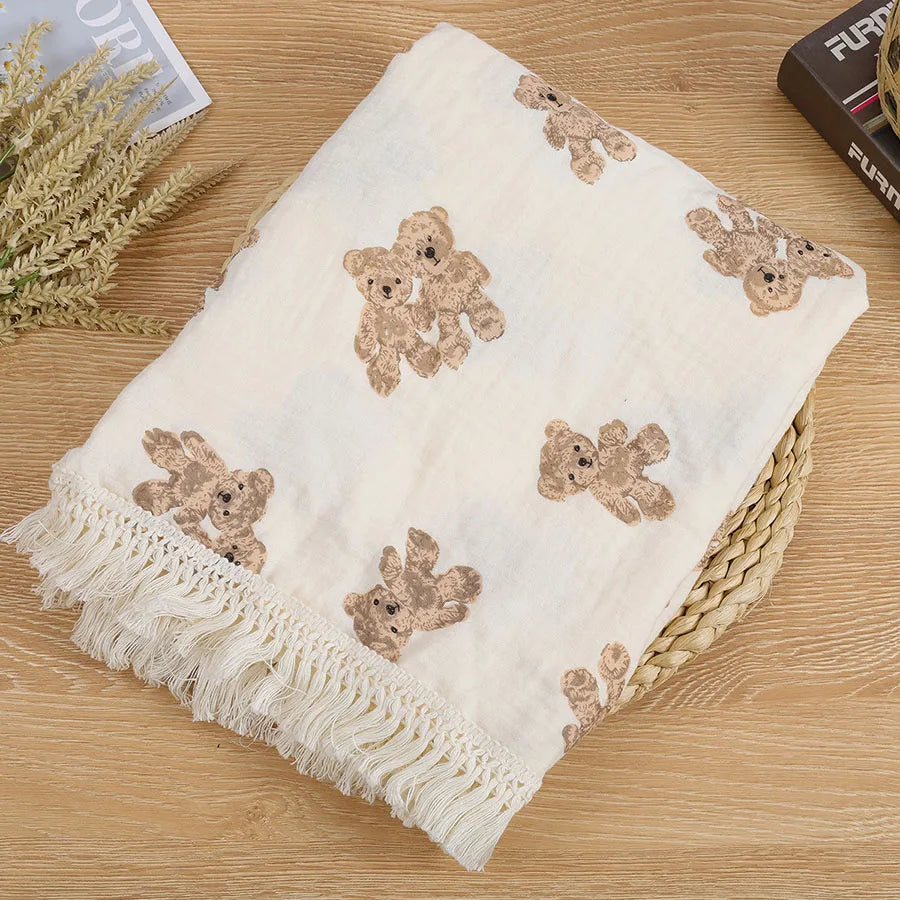 "Featuring a charming bear design and breathable cotton muslin fabric, this blanket is made for sweet dreams and gentle cuddles."
