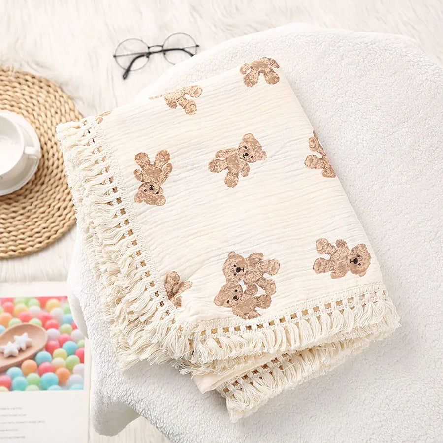 "Featuring a charming bear design and breathable cotton muslin fabric, this blanket is made for sweet dreams and gentle cuddles."